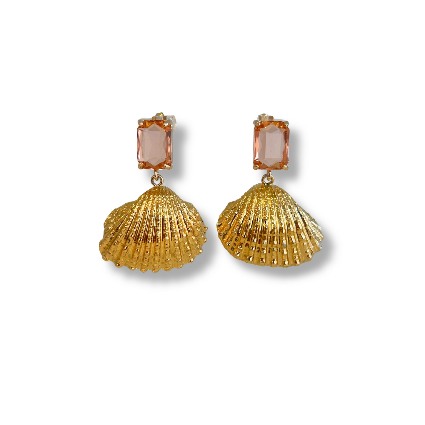 Gold shell earrings with pink gemstones on a white background