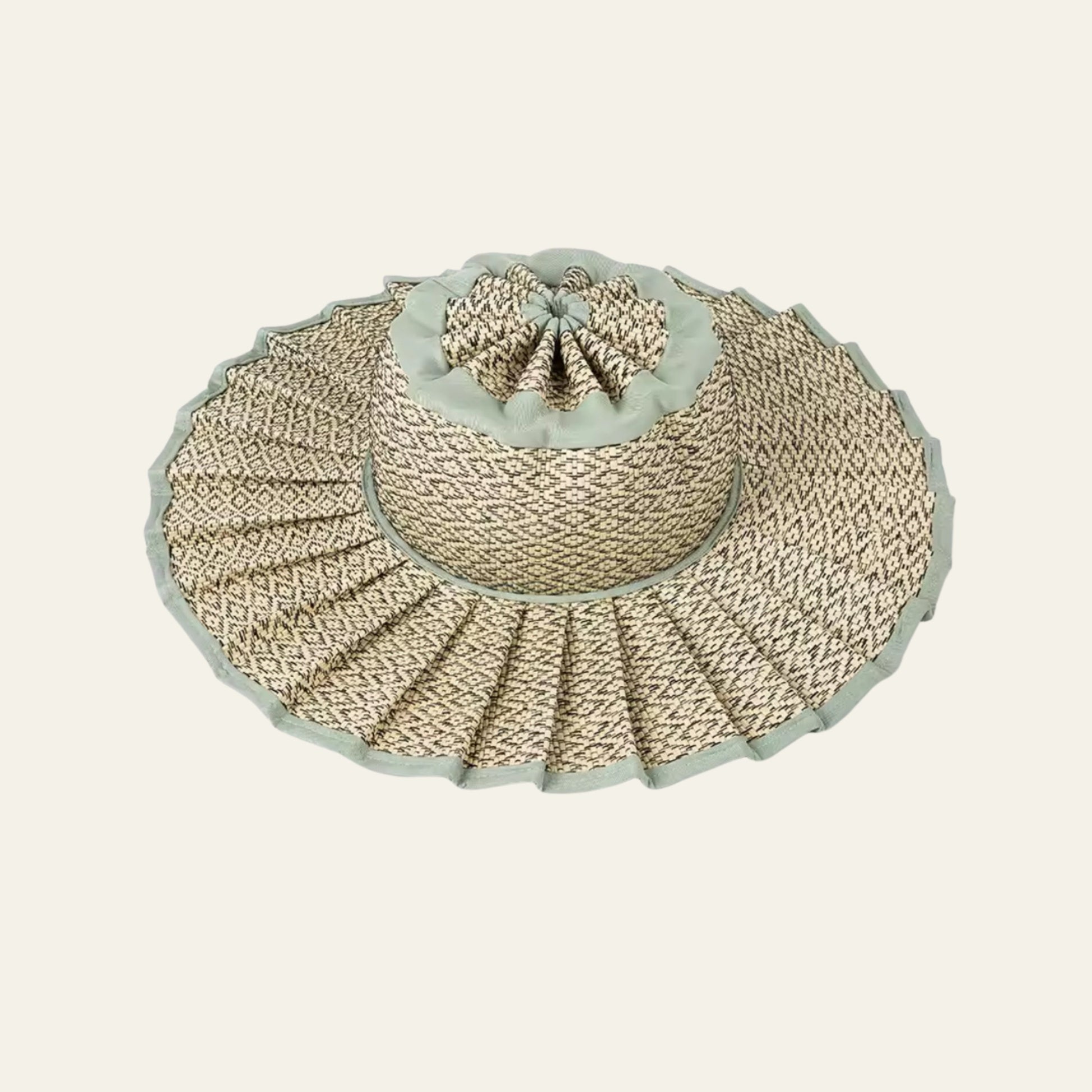 Woven straw hat with a light blue trim on a white background foldable pleated and waterproof