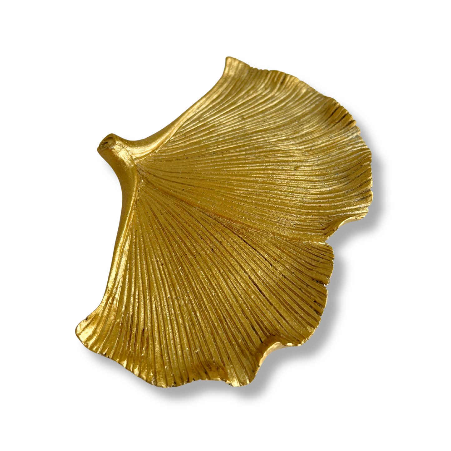 Gold leaf-shaped decorative catchall tray on a white background